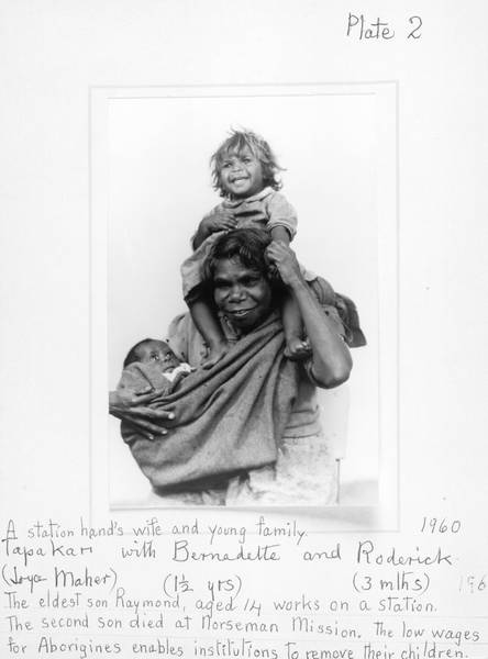 'A station hand's wife and young family: Tapakari (Joyce Maher) with Bernadette (1½ years) and Roderick (3 mths). The eldest son, Raymond, aged 14 works on a station. The second son died at Norseman Mission. The low wages for Aborigines enables institutio