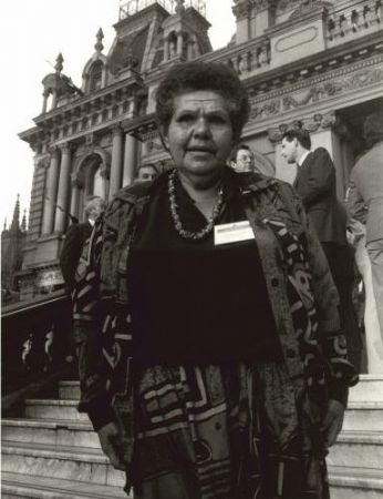 Shirley Smith on the steps of Town Hall in Sydney, several unknown people are in the background.