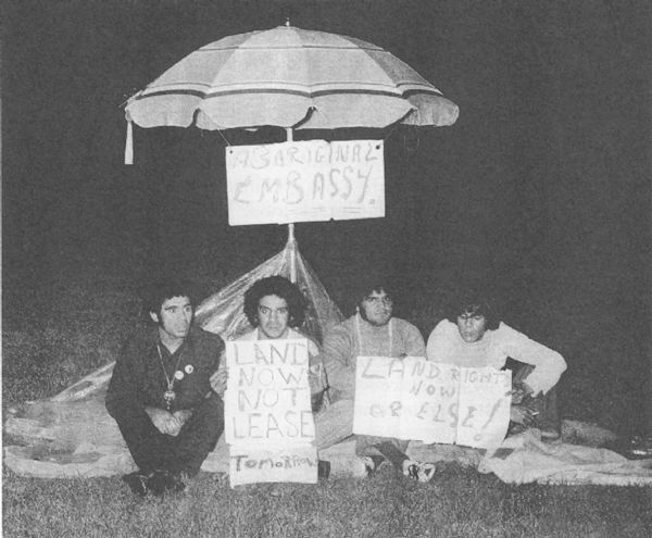 Angered at the federal government's Australia Day statement rejecting Aboriginal land rights, these four men drove from Sydney to Canberra to set up their protest under a beach umbrella.