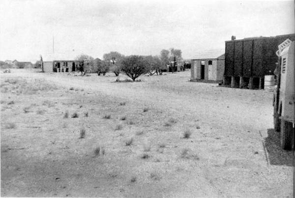 View of meteorological station buildings on right edge, most of the image is desert landscape.